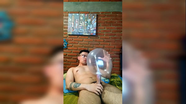 Active cock masturbates with a condom balloon